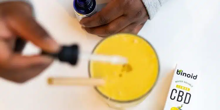 Person Holding A Dropper And Putting Medicine On A Drink
