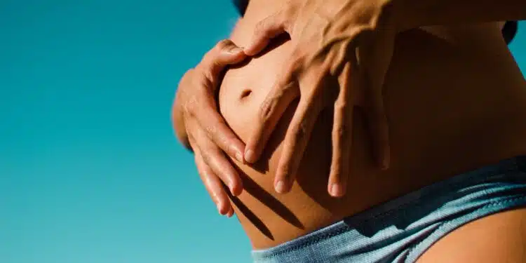 closeup photography of pregnant woman wearing blue panty