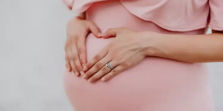 woman wearing gold ring and pink dress